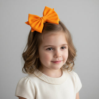 Large orange bow on a white background