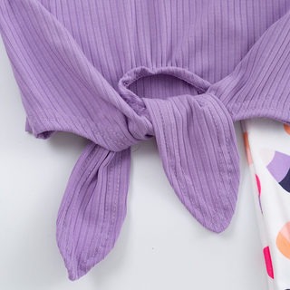 Close-up of a purple ribbed top with a knot detail on a white background
