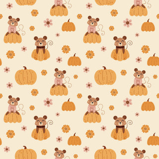 A repeating autumn-themed pattern featuring cartoon pumpkins, small pink flowers, and brown mice sitting on pumpkins, set on a warm cream background.