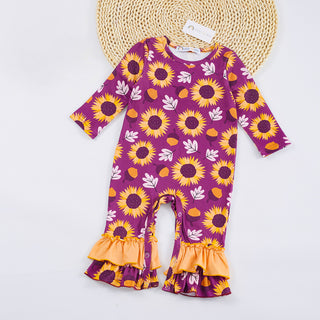 Purple baby romper with sunflower pattern on a white background
