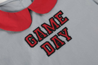 Gray shirt with 'GAME DAY' text in red and black on a gray background