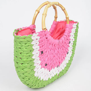 Woven handbag with pink and white floral pattern on a light gray background