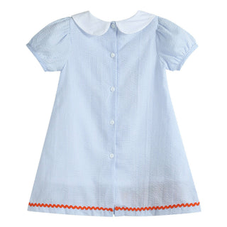 Light blue striped dress with white collar and red trim on a white background