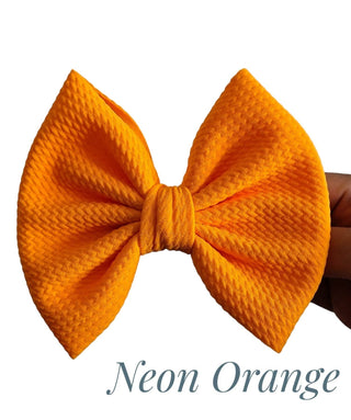 Neon orange bow with 'Neon Orange' text on a white background