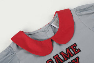 Gray dress with red collar and 'GAME TIME' text on a white background
