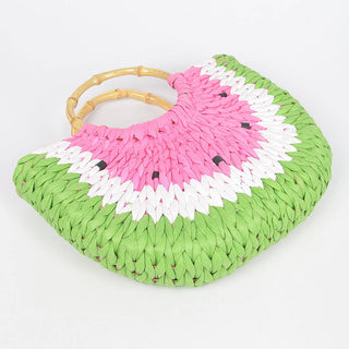 Woven handbag with pink and green design on a white background