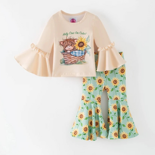 Children's outfit with beige top and sunflower-patterned pants on a white background