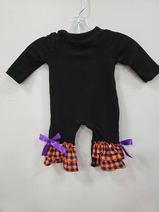 Black long-sleeve top with plaid and purple bow details on a light gray background