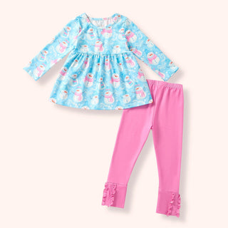 Children's outfit with blue top and pink pants on a white background